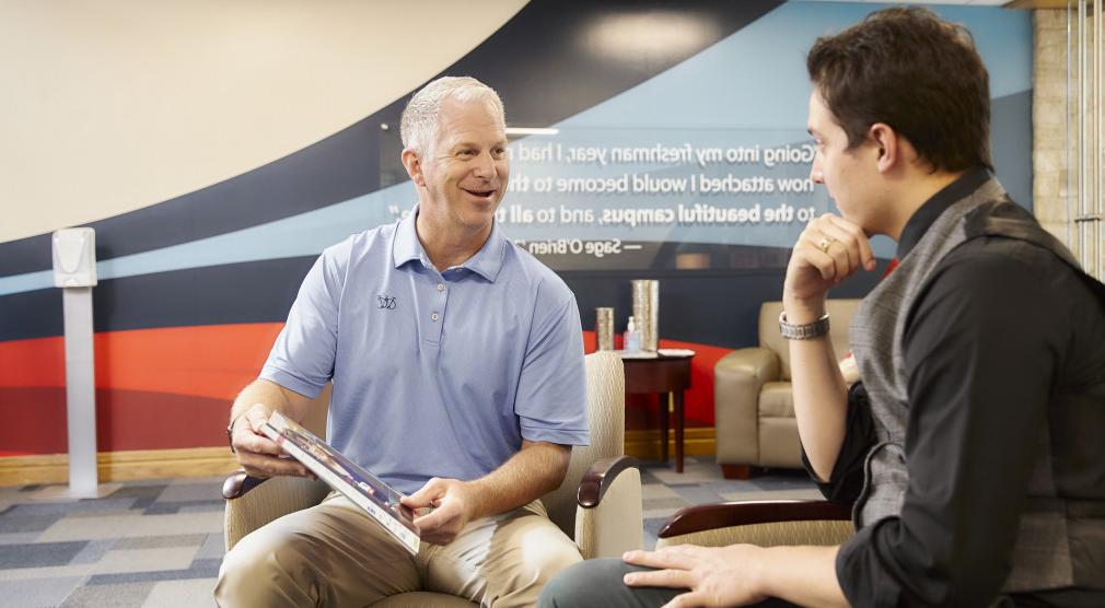 Admissions representative Greg Huss meets with a student.